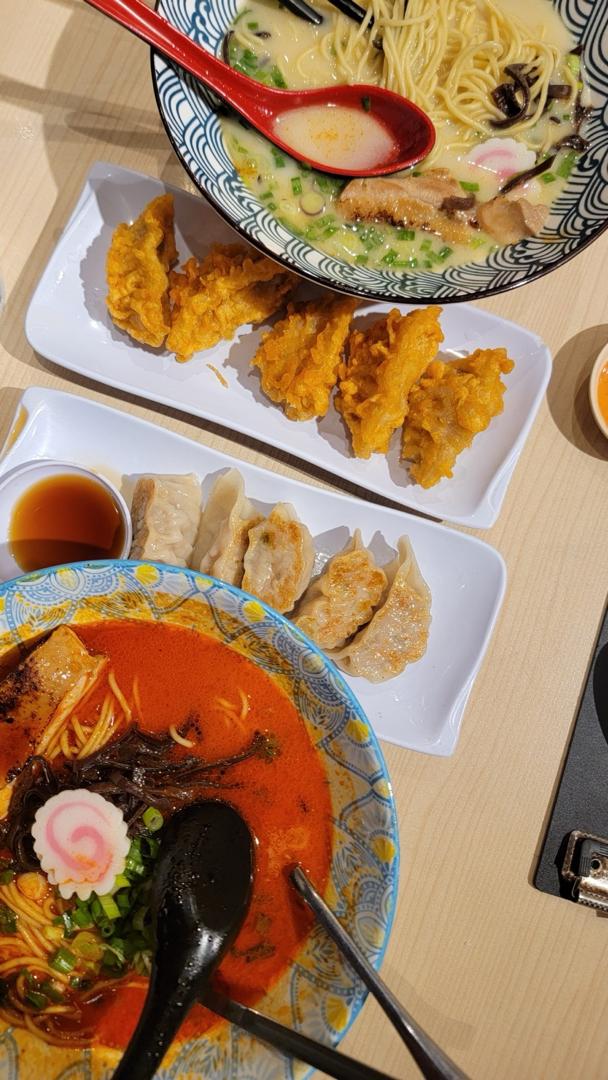 Two bowls of ramen, gyoza and fried sides at Lot 10
