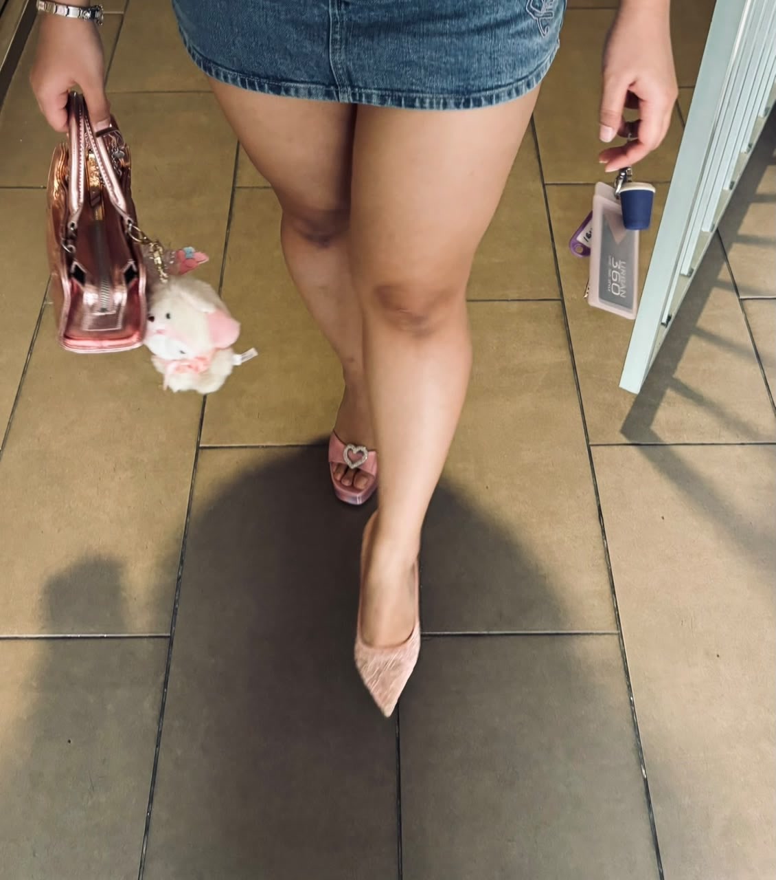 Sera's pink heels, denim skirt and matching bag