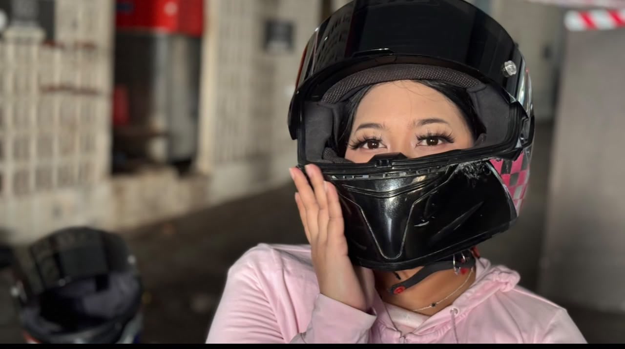 Sera looking through a motorcycle helmet
