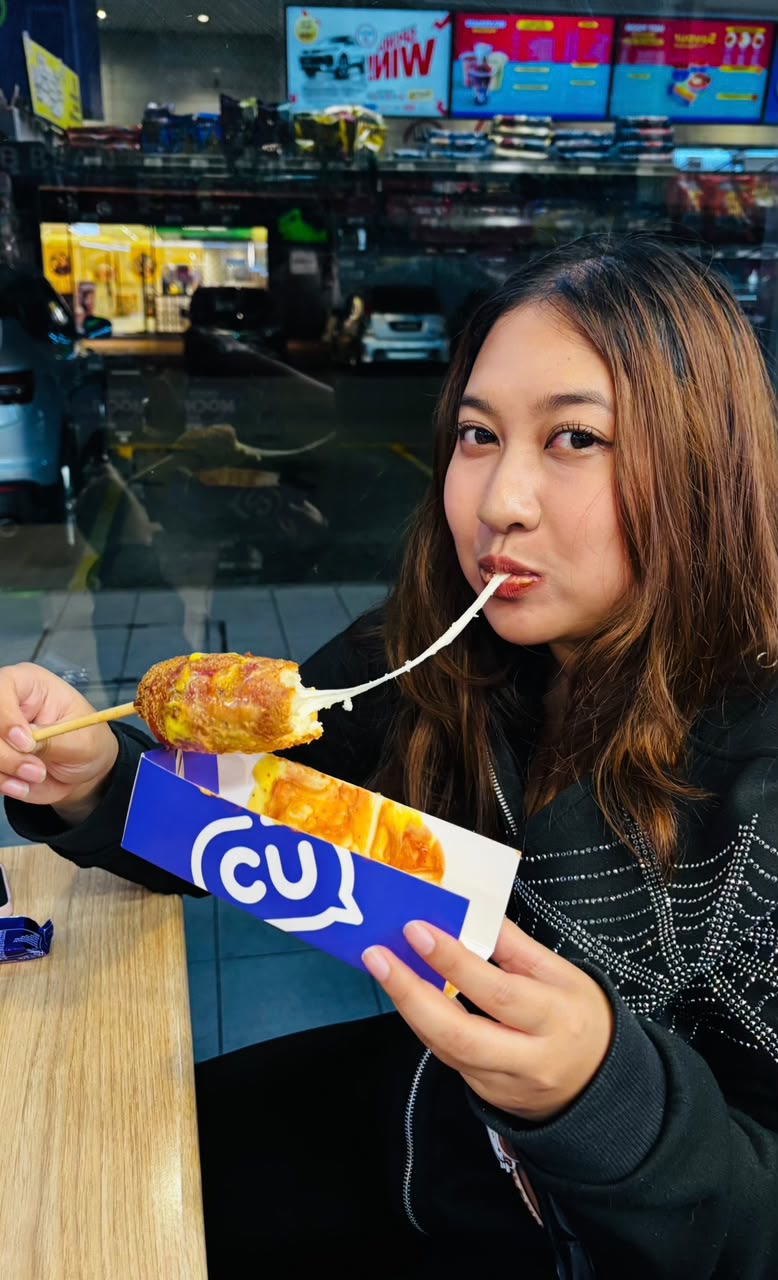 Sera eating a stretchy cheese snack