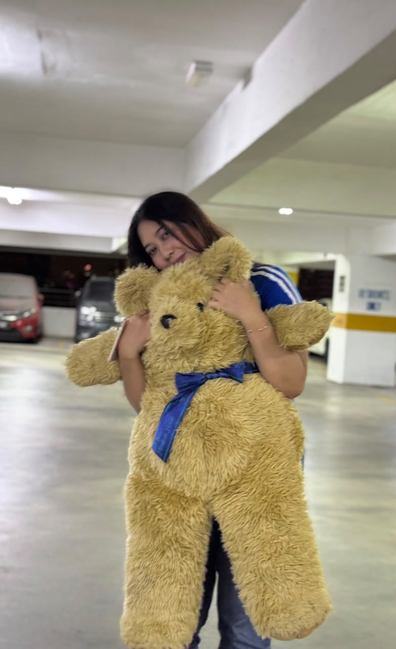 Sera hugging an enormous teddy bear