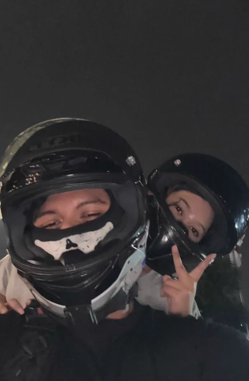 The two of you wearing motorcycle helmets at night