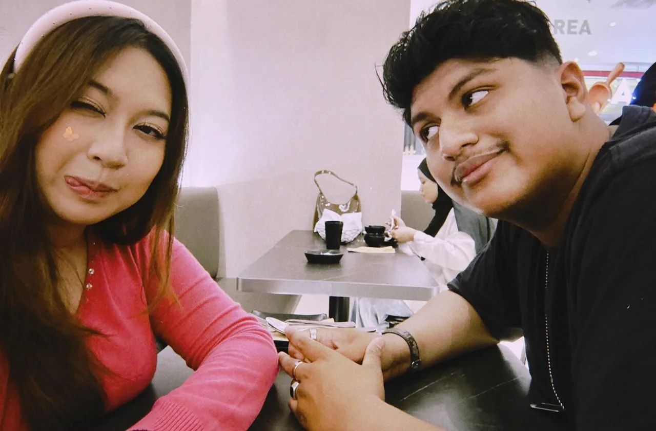 The two of you holding hands across a cafe table